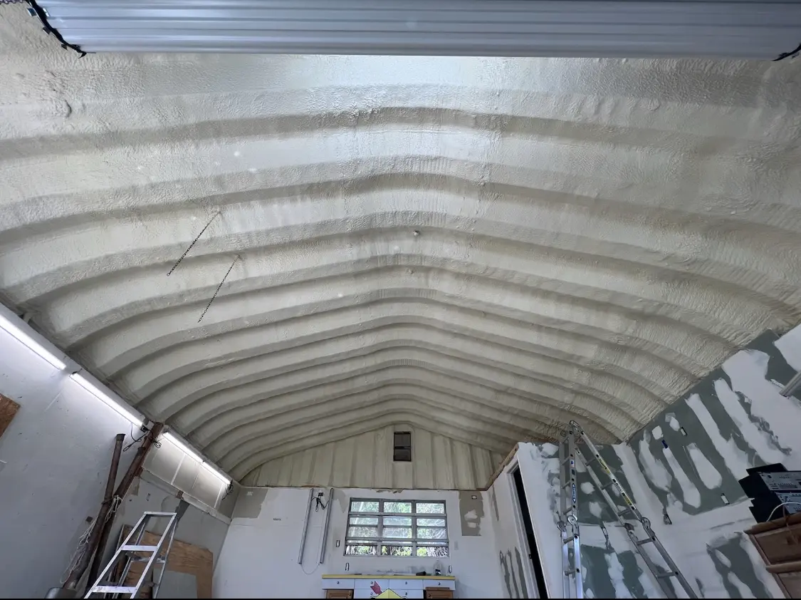 Spray polyurethane foam applied to the underside of a metal roof deck in Russellville
